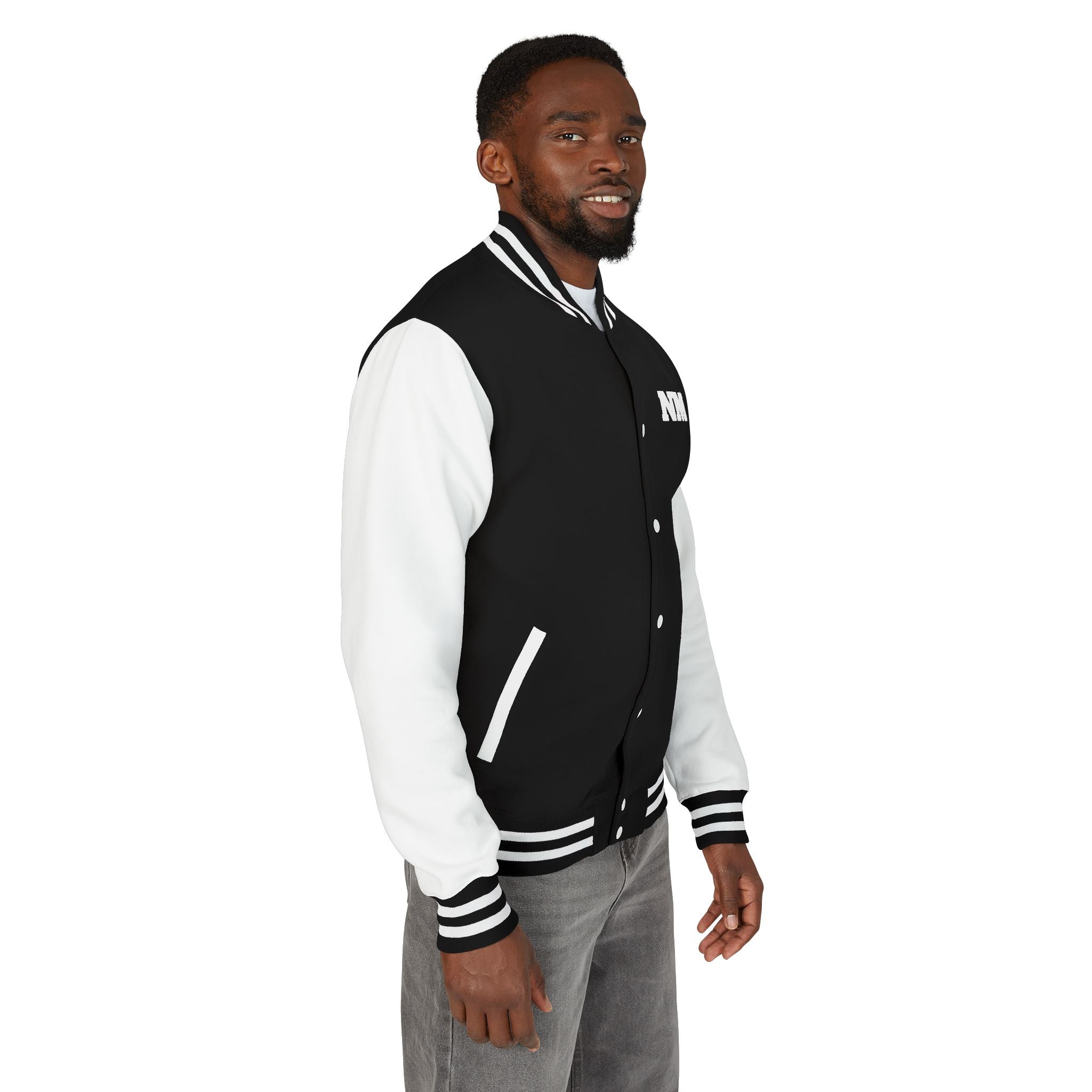 side view of a Man wearing a black and white varsity jacket