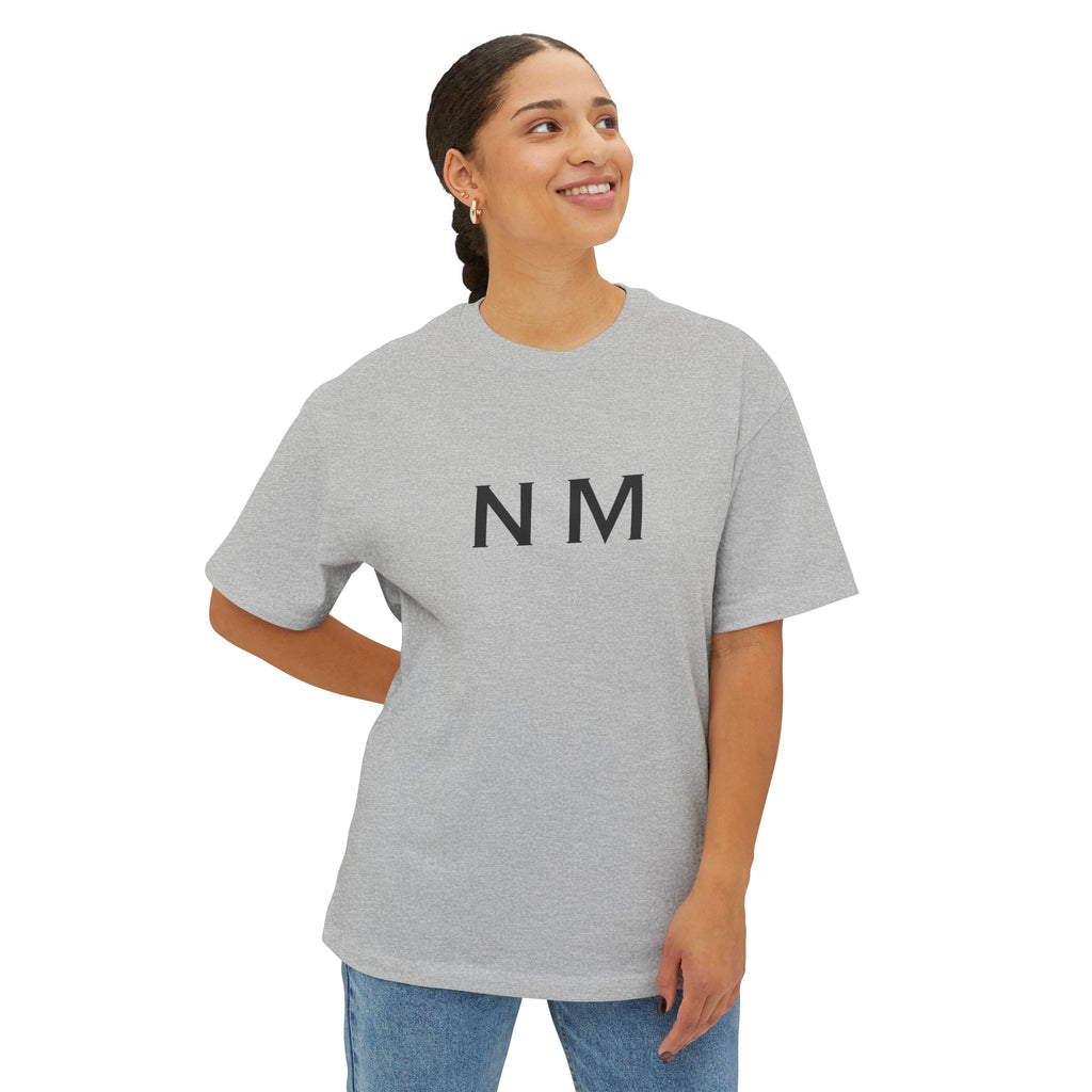 Person wearing a gray t-shirt with 'NM' text
