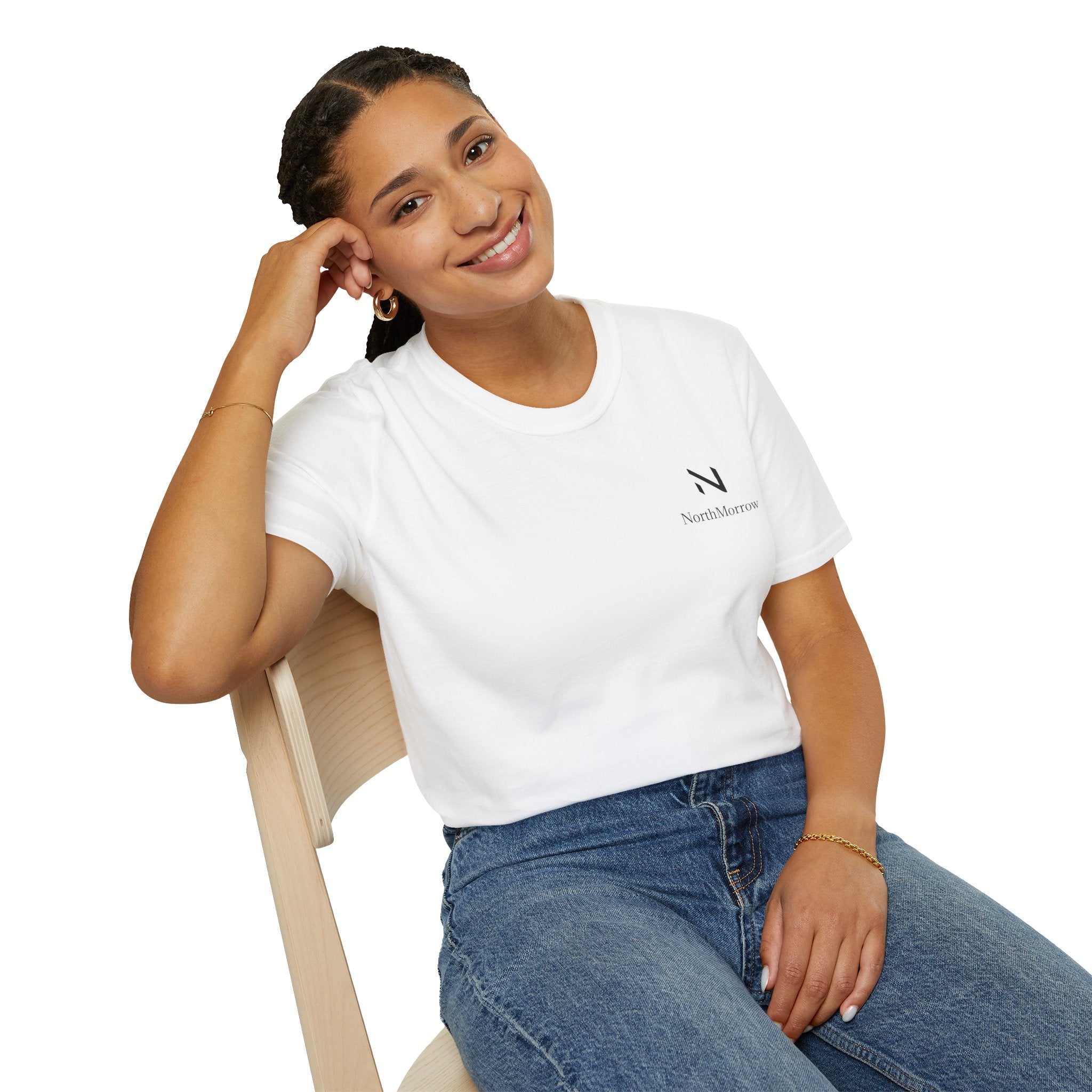 Woman wearing a white t-shirt with a logo and blue jeans, sitting on a chair 