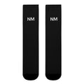 Two black socks with 'NM' logo on a white background